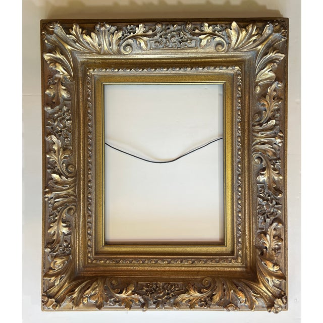 This ornate Rococo Baroque style wall frame features a deeply carved gold motif with elegant details throughout. This is a...