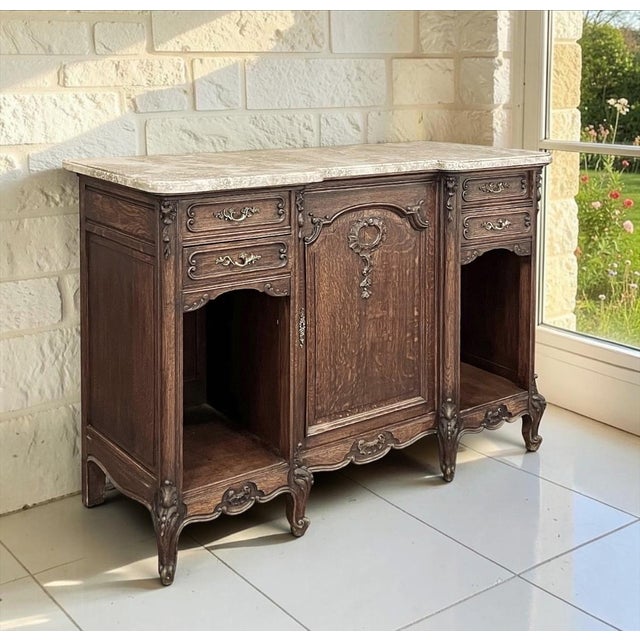 Antique French Louis XV style display buffet crafted from richly figured oak and crowned with a beautifully contoured...