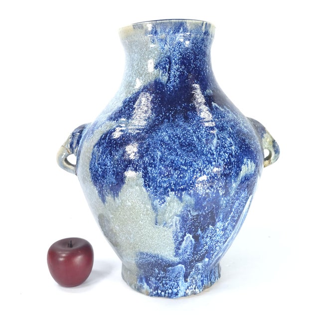 There are stunning colors exhibited in these large reduction glazed pot. This pot has two elephant handles on either side....