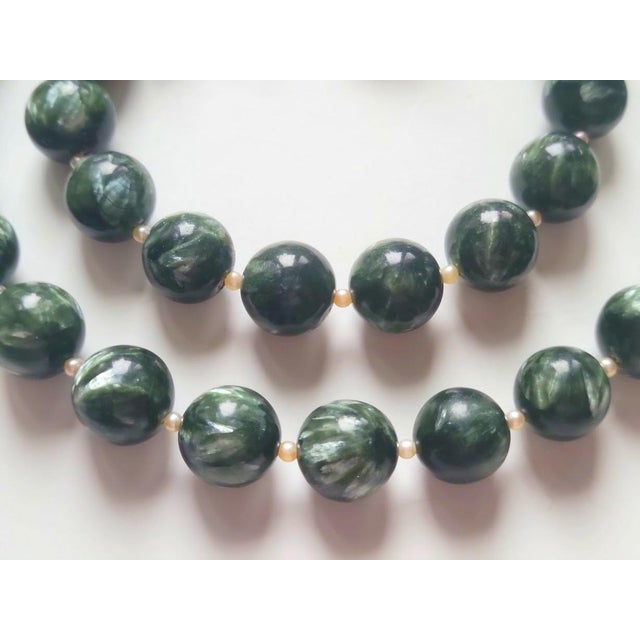 Discover the captivating beauty of this Natural Seraphinite and Freshwater Pearl Necklace, handcrafted with large 13.5 mm...