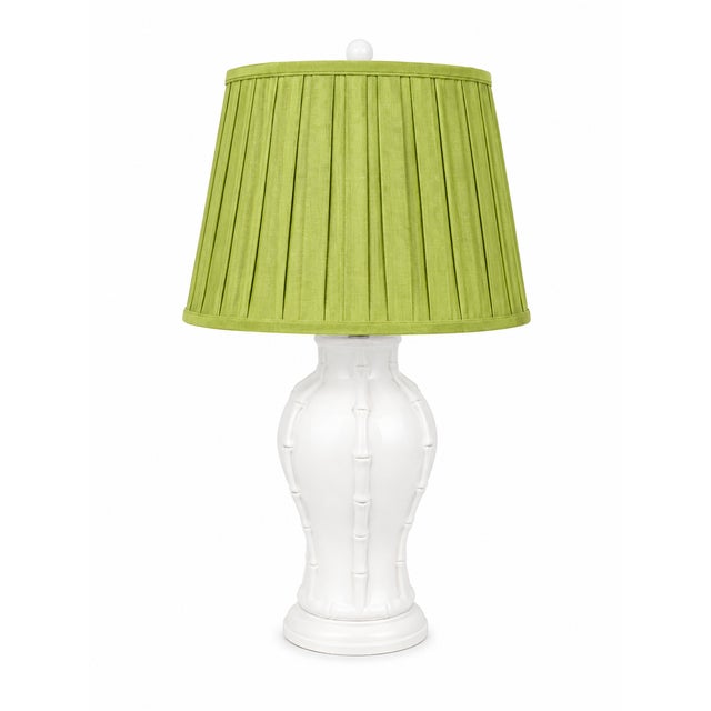 A charming vintage ceramic table lamp featuring a sculptural urn-form body with raised faux-bamboo detailing. Finished in...