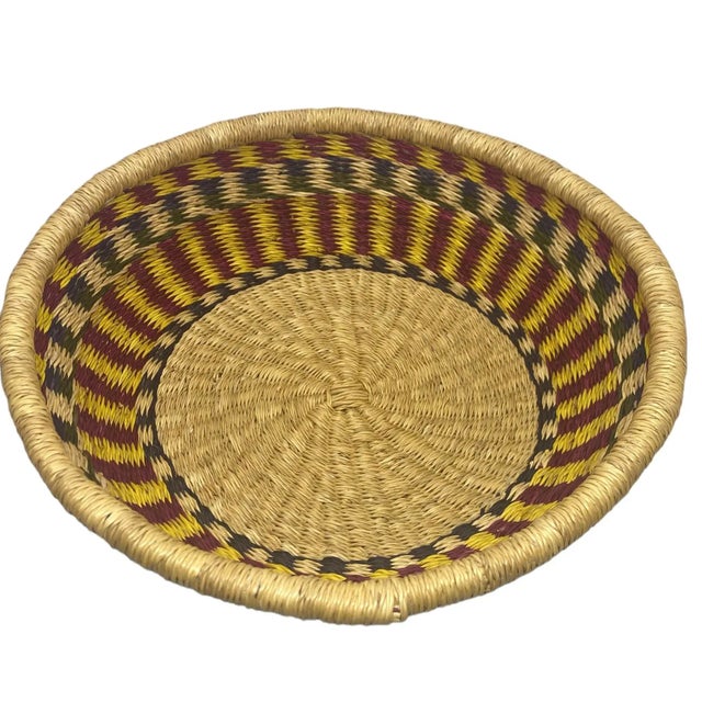 Introduce a burst of color to your home with this vintage hand-woven basket. Measuring 14 inches in diameter, it showcases...