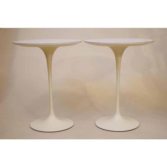 A striking and futuristic matched pair of Atomic Modern "Tulip" White laminate side floor tables designed by Eero Saarinen...