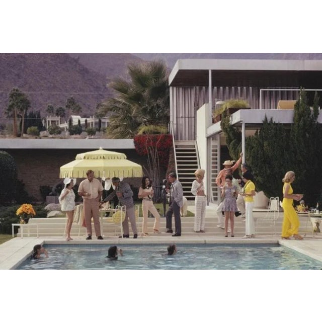 Poolside Host 1970 by Slim Aarons Slim Aarons Limited Estate Edition Guests by the pool at Nelda Linsk’s desert house in...