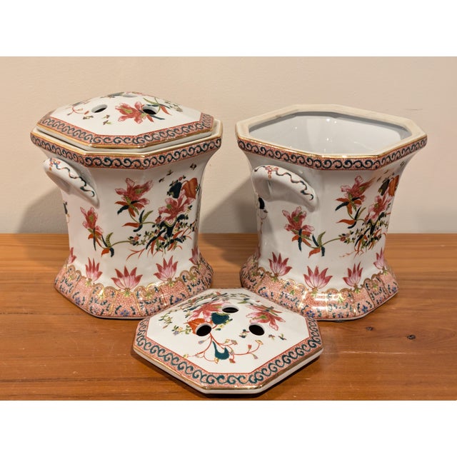 A pair of striking floral Chinese porcelain potpourri jars. The jars are square or octagonal with a pair of handles and a...