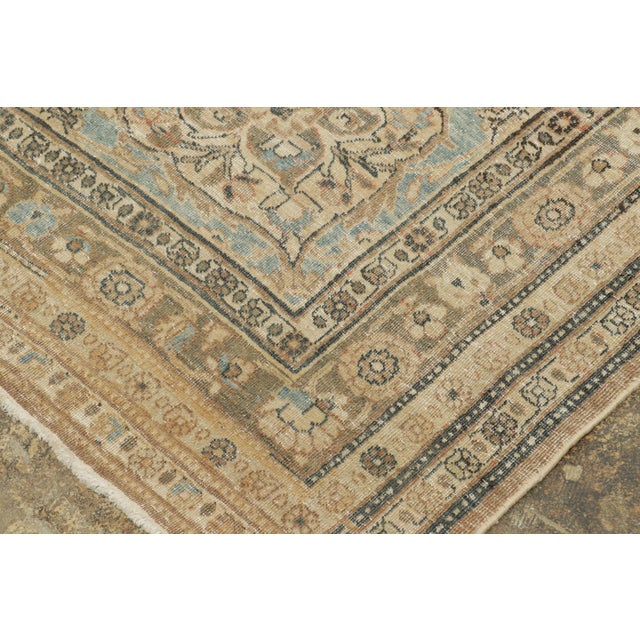 Handwoven in wool, this oversized antique 11x17 Persian Tabriz rug dates to circa 1920–1940. The rug features an all-over...