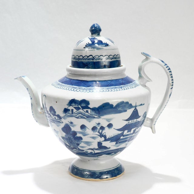 A fine antique Chinese Export porcelain tea pot. In the Canton pattern. Decorated in underglaze blue with a mountainous...