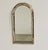 A highly decorative vintage spanish mirror featuring an elegant arched silhouette and an elaborate combination of gilt...