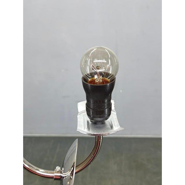 Elegant art deco chandelier produced in czechoslovakia during the 1930s. Crafted from chrome-plated metal, beech wood, and...