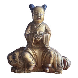 Chinese Carved Wooden Quan Yin or Ancestor Figure on Foo Dog Incense Holder. Beautiful Carving Sang De Bouef Undertones With Gold Overlay. For Sale