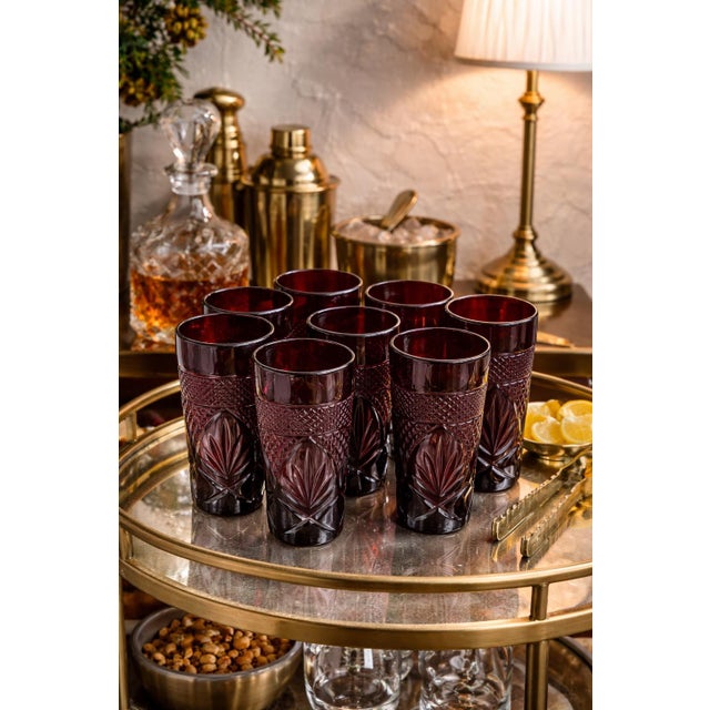 Elegant set of eight ruby red cut crystal tumblers by Crystal d’Arques, France, known for their refined craftsmanship and...