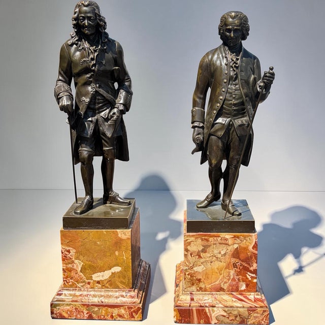 After D’après Houdon, unsigned. Pair of sculptures representing Voltaire and Rousseau in full length after Houdon in...