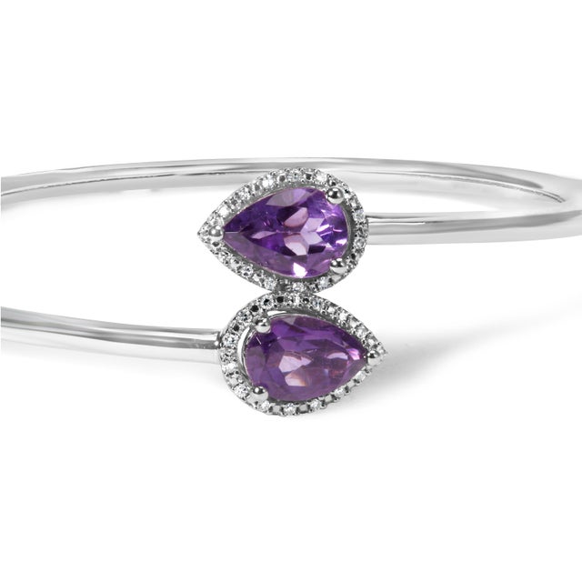 Indulge in the exquisite beauty of this .925 Sterling Silver Bangle Bracelet. Adorned with a dazzling 8 x 5.5mm Pear Shape...