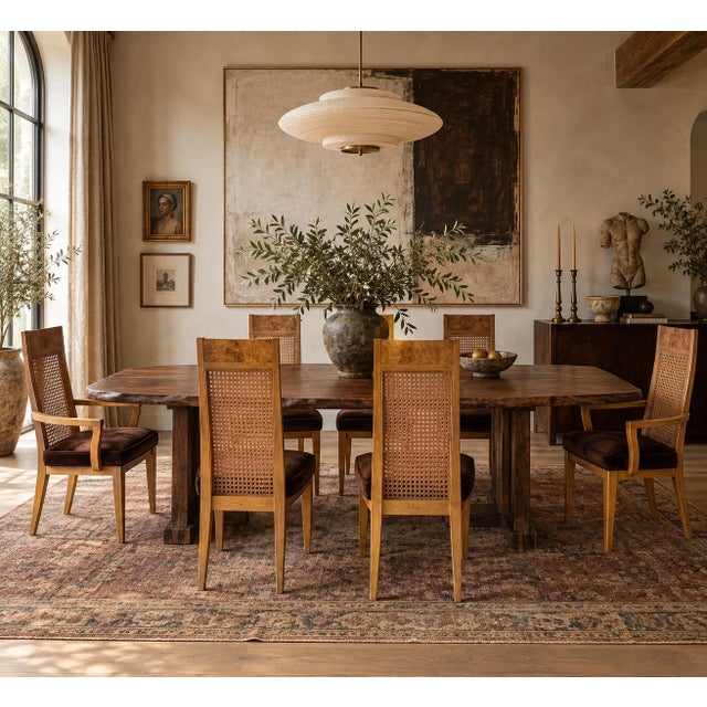 These vintage dining chairs bring texture and height to a table in equal measure. Tall cane backs are framed in warm burl...