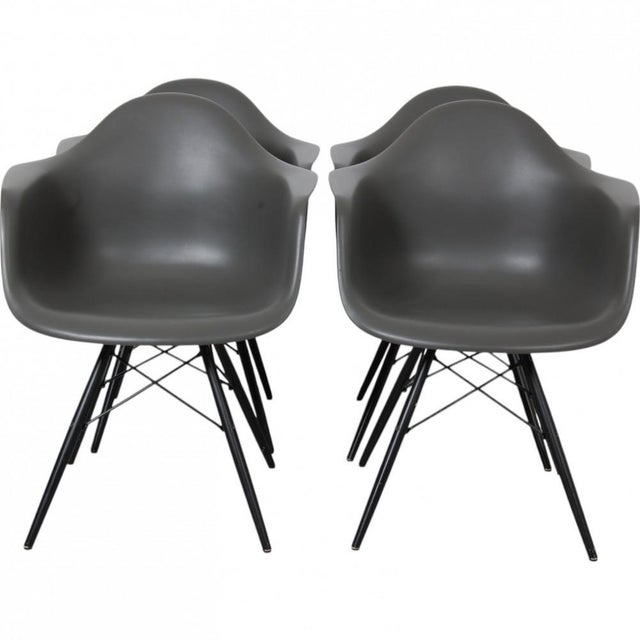 Set of 4 Charles Eames Umbra DAW armchairs with black painted maple legs. The chairs are from 2016 and appears in good...