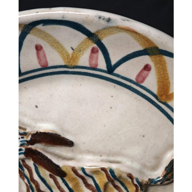 Rare Italian artistic ceramic plate dating back to the 1930s-1940s, signed "Italy" on the back. The plate features a...