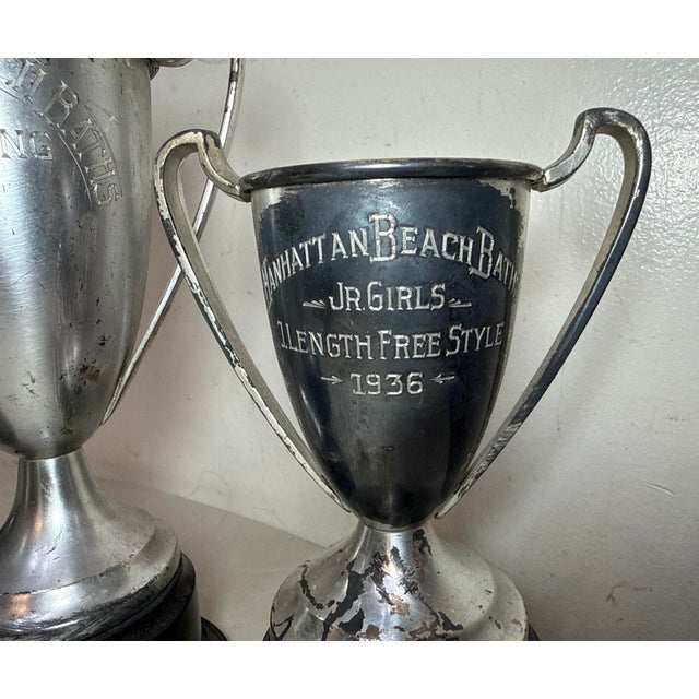Up for sale is a set of three antique 1930's Manhattan Beach Baths women's swimming silver-plate and bakelite trophies....