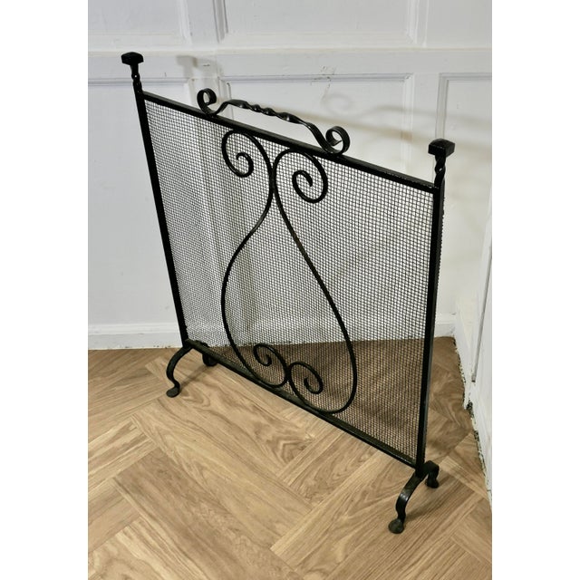 Large Old Wrought Iron Fire Screen This is a very useful piece, with a fine mesh guard and decorative iron work In good...