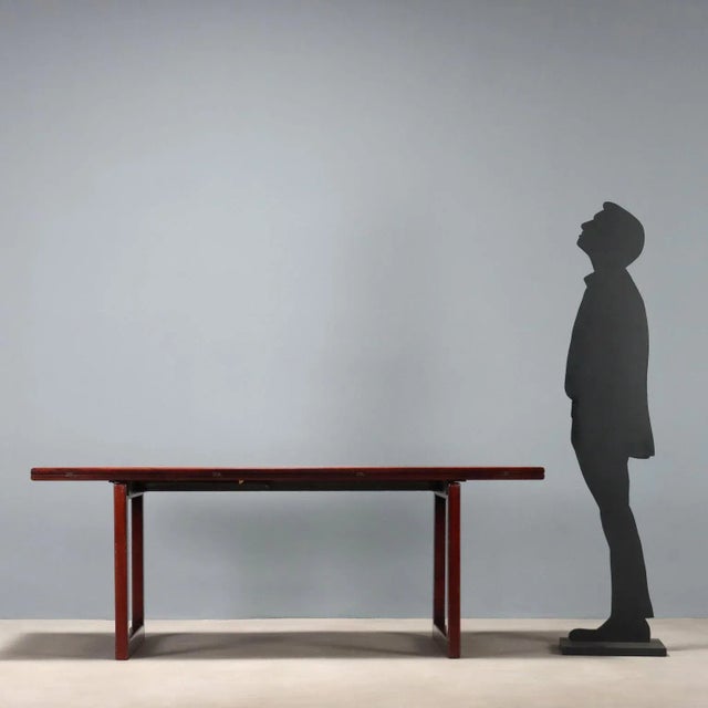 Elegant table with a wooden frame and exotic wood veneer, featuring two trestle legs and a top that can be extended by...