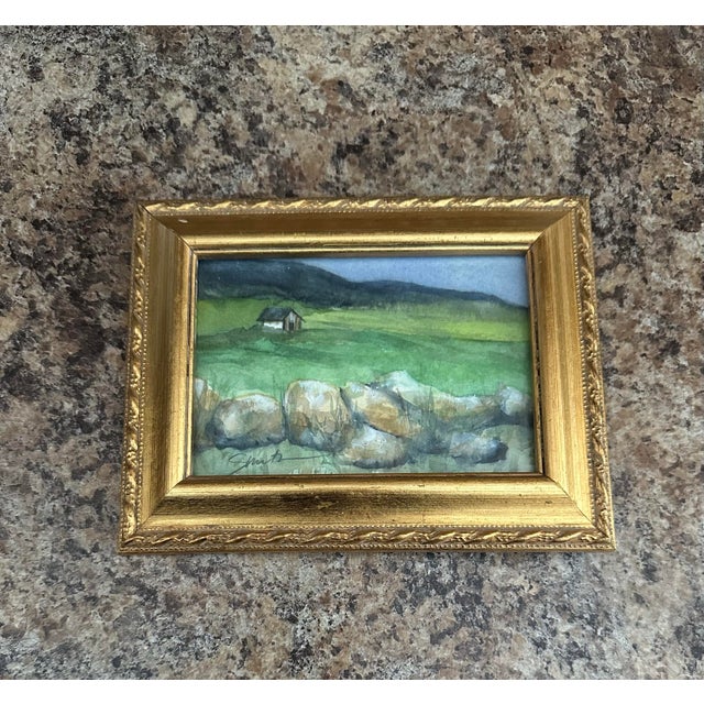 A peaceful countryside scene featuring rolling green hills, a rustic stone wall, and a lone cottage nestled in the...