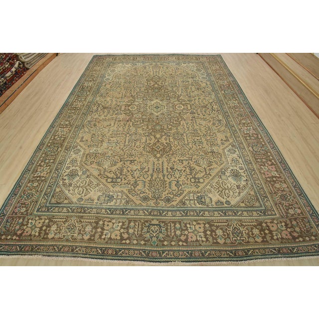 An authentic vintage traditional Tabriz rug hand-knotted with fine wool and natural dyes. This oriental rug features a...