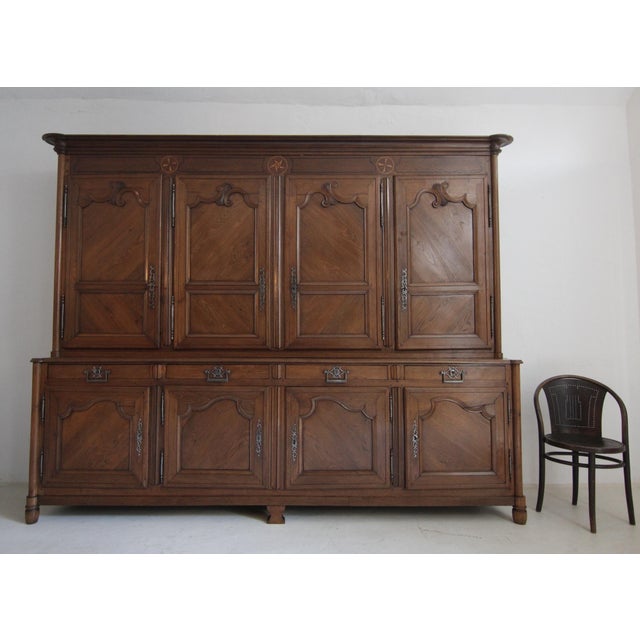 A large 19th century French cabinet or buffet à deux corps made of solid oak wood. The oak body stands on 6 feet and is...