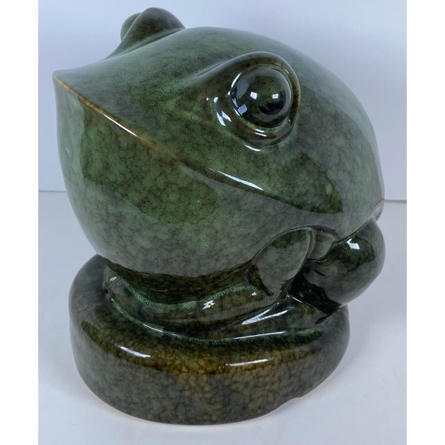 A striking French Art Deco style ceramic frog sculpture, executed in a bold and highly stylized form with smooth,...
