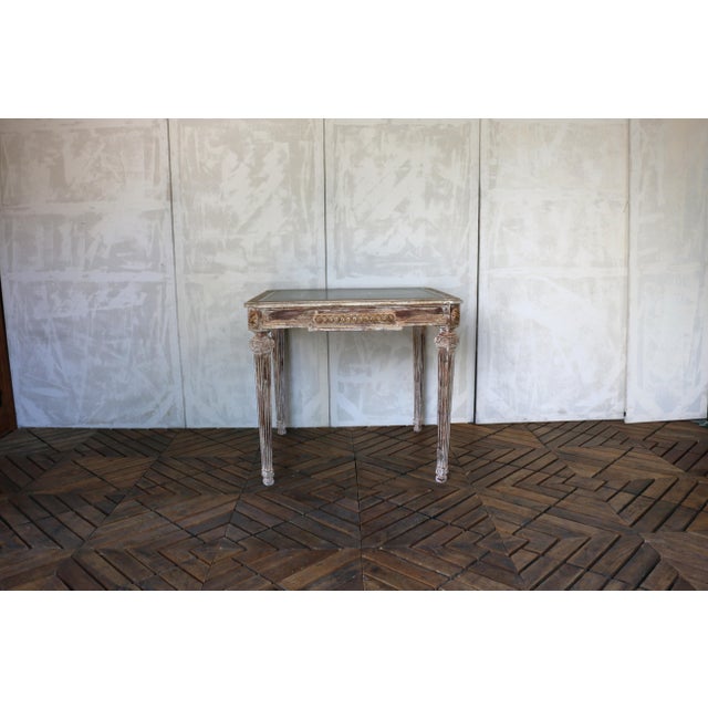 A charming Italian Neoclassical game table dating to the 1930s, crafted from solid wood and featuring a beautifully aged...