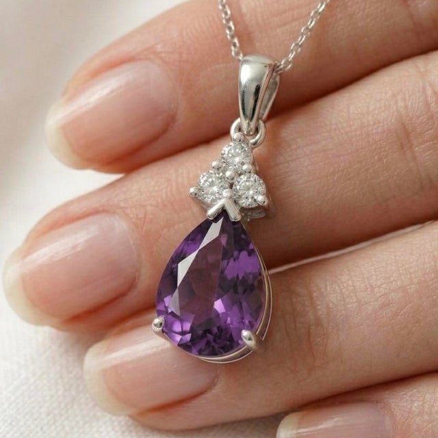 This stunning pendant features a deep, regal Amethyst, a gemstone long admired for its rich violet tones and timeless...