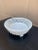 An elegant trompe l'oeil porcelain cachepot crafted in the form of a handwoven rope basket. Executed in glossy white...