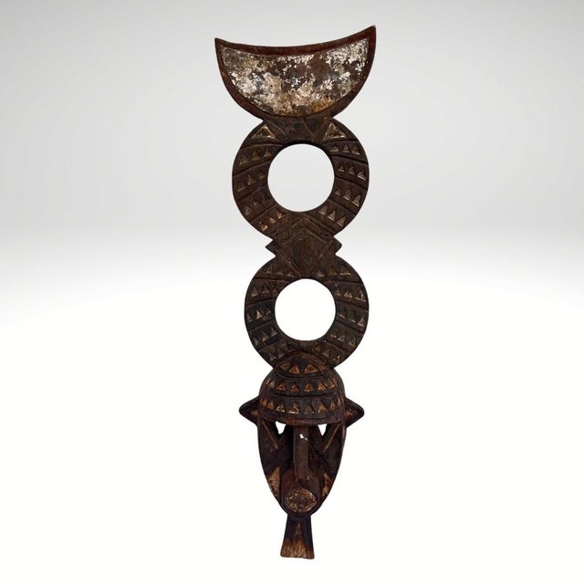 This Bobo wooden mask from Burkina Faso is a powerful example of traditional West African ritual sculpture associated with...