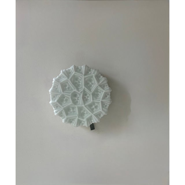 Pair of wall sconces, each with an opaline glass diffuser and a chrome-plated metal base, produced in Sweden in the 1960s....