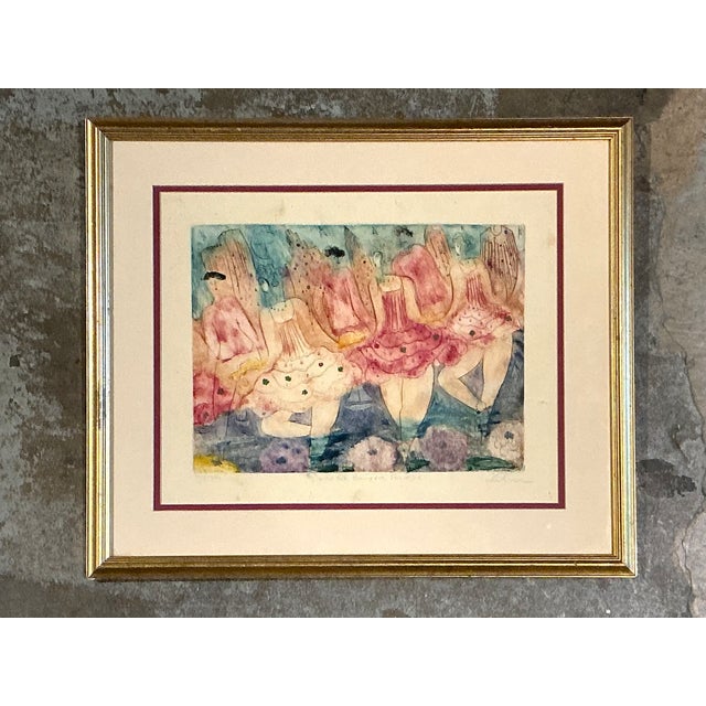 This charming vintage framed print captures the lyrical beauty of ballet through a whimsical composition of dancers in...