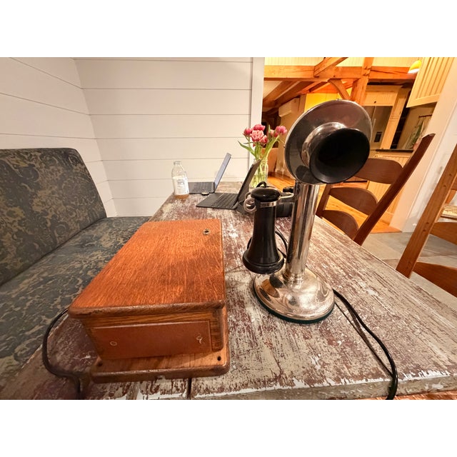 An antique phone that works, but with a little twist. It has a keypad. The phone part and base are solid metal, and the...