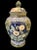 A beautiful clay ginger jar with pretty green and navy blue colors. The jar has a lid with an artichoke top. The sides are...