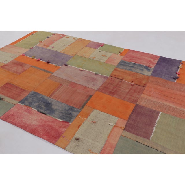 Handwoven in cotton and wool, this 7x10 vintage Anatolian patchwork rug, circa 1950-1960, is a striking example of mid-...