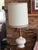 Pair of Mid-Century Modern / Brutalist style ceramic and teak wood table lamps, featuring a textured white/cream ceramic...