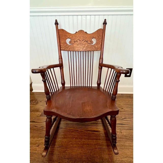 Beautiful antique rocker circa 1850-1915. The chair is solid tiger oak and it features a carved crest rail, vertical...