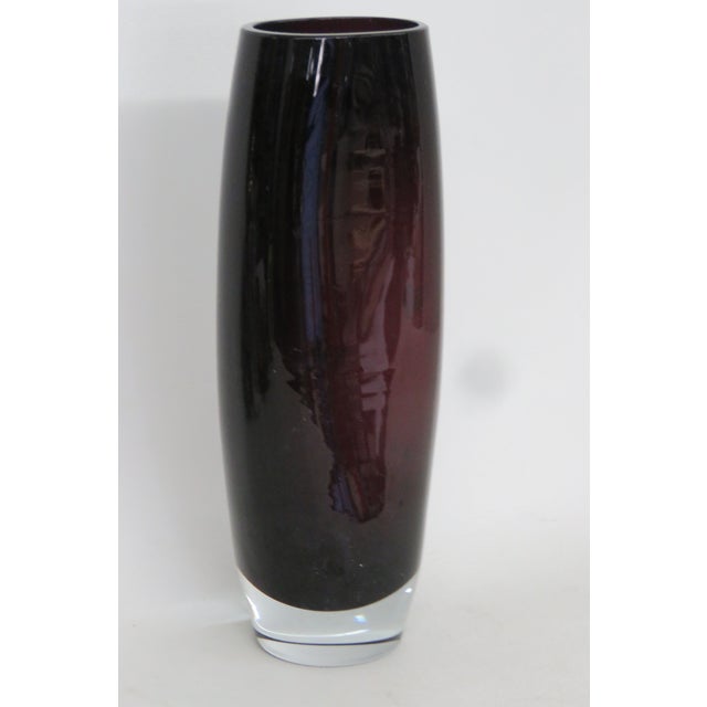 This is a charming sculptural glass vase presents a stunning deep purple color with a clear glass bubbled bottom. This...