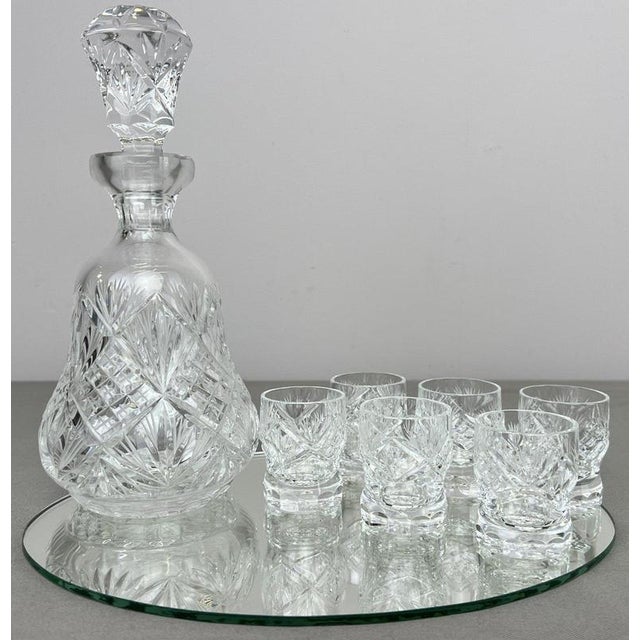 An elegant Vintage crystal cut carafe set , featuring a decorative cut design and supplied with 6 shot glasses, a tray and...