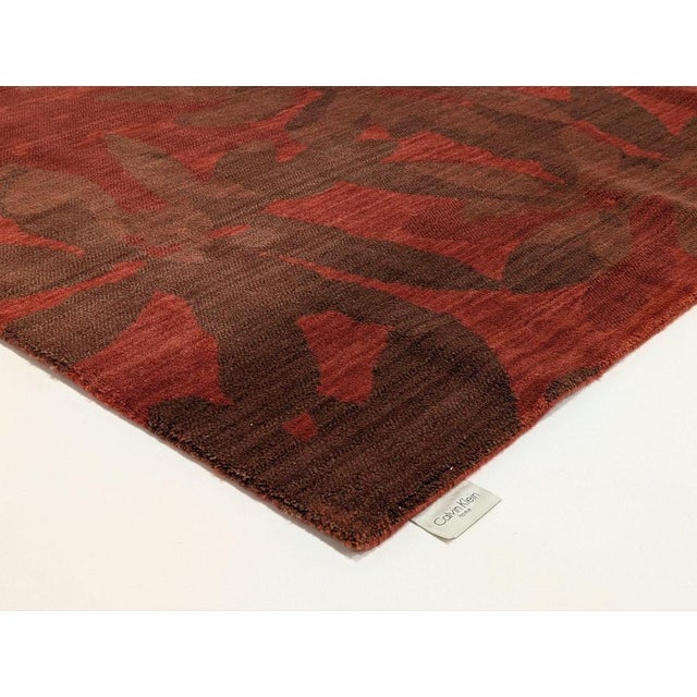 Urban Winter Flower Rug Garnet – Constructed of a fine wool blend, combine layered and graphic abstracts in complimentary...