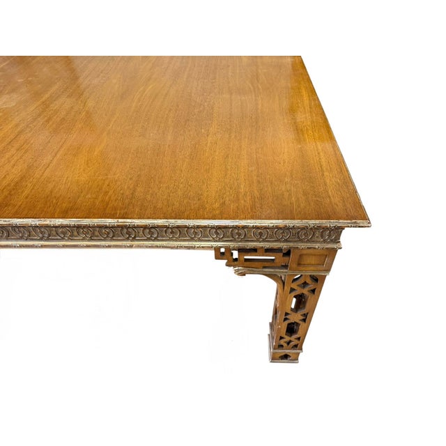 Dennis & Leen Chinese Chippendale Mahogany & Giltwood Dining Table. It includes two 24” leaves which extend the table to...