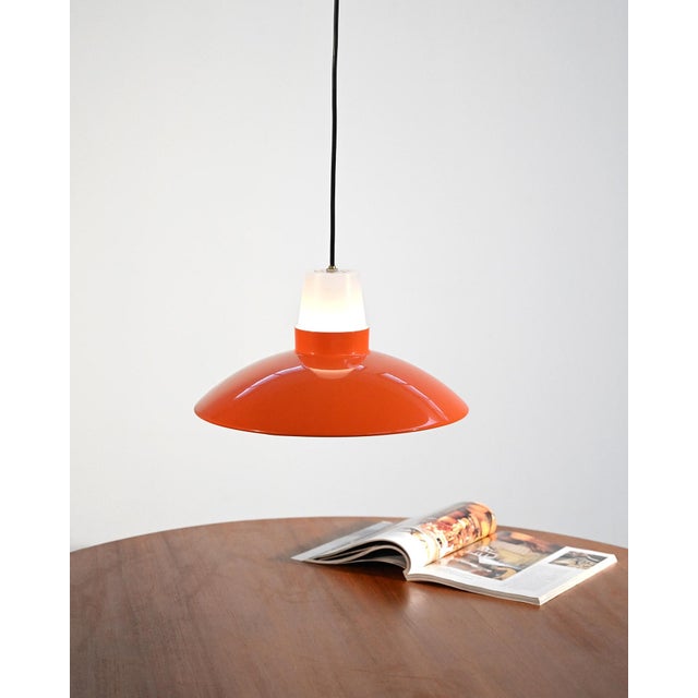 Ceiling lamp in metal and orange and white plastic with a curved diffuser. Attributed to Sven Middelboe for Nordisk Solar....