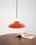 Ceiling lamp in metal and orange and white plastic with a curved diffuser. Attributed to Sven Middelboe for Nordisk Solar....