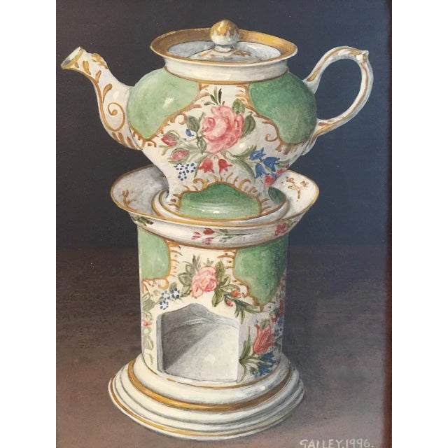 Charming still life painting of an English porcelain teapot and candle warmer. The pale green teapot is decorated with...