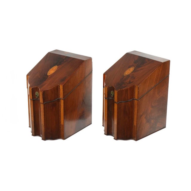 Mahogany cases, serpentine fronts, hinged lid with shell inlaid medallion. Checkerboard banded trim.