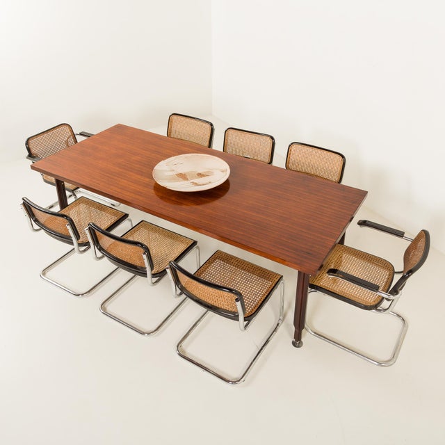 Refined Italian extra-long, mid-century rosewood table was made in the 1960s, exemplifying the elegance and craftsmanship...