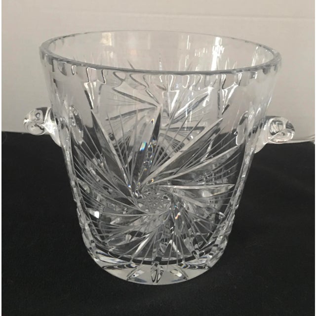 Elegant brilliant cut crystal ice bucket with pinwheel design . Snail shaped handles . Circa 1990’s Free of any chips ,...