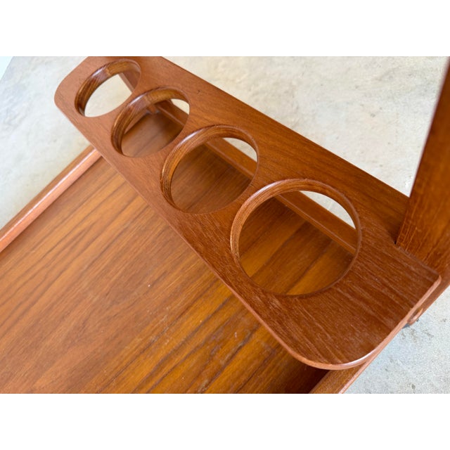 Elegant Mid-Century Danish Modern cocktail trolley or bar cart crafted in warm teak wood with clean minimalist lines and...