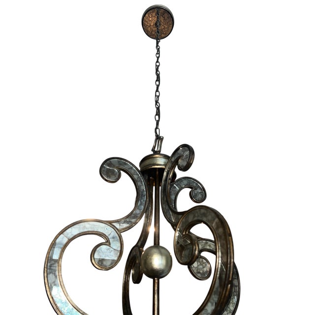 The John-Richard eight-light chandelier (model AJC-8677) measures 33 inches high by 33 inches wide. It features an antique...